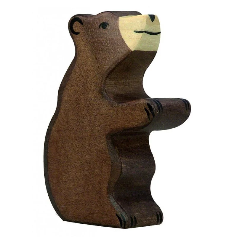 Holztiger standing brown bear cub